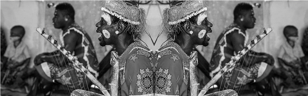 Gabonese cultural musicians in traditional dress and ceremonial face paint
